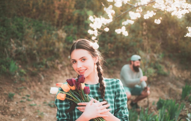 Beautiful woman gardener with flowers