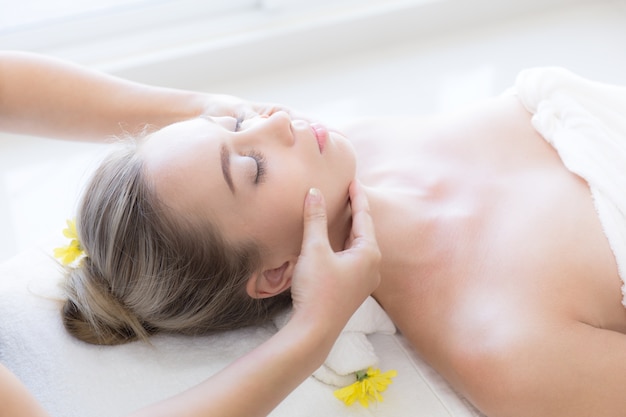 Beautiful woman getting facial massage in spa salon , Health and beauty concepts