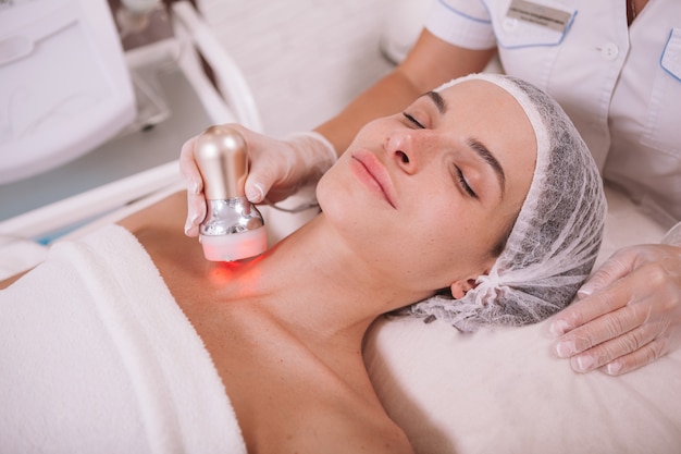 Beautiful woman getting rf lifting skincare treatment