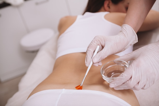 Beautiful woman getting skincare treatment at cosmetology clinic