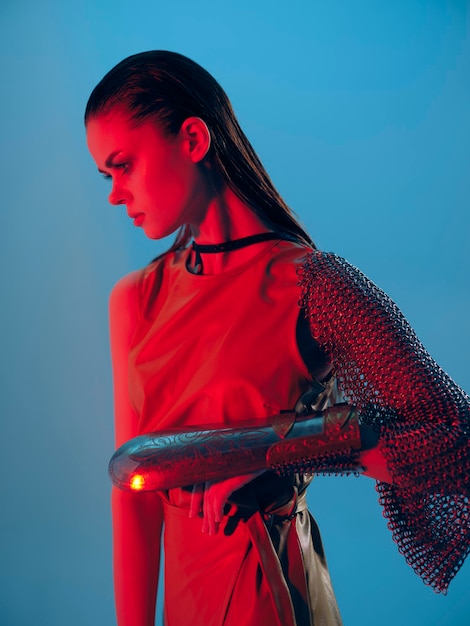 Beautiful woman Glamor posing red light metal armor on hand Lifestyle unaltered