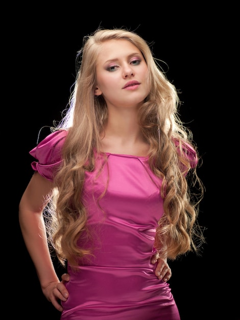 Beautiful woman in a gray suit against a dark background in the office