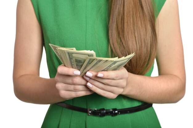 Beautiful woman in green dress with money on white background
