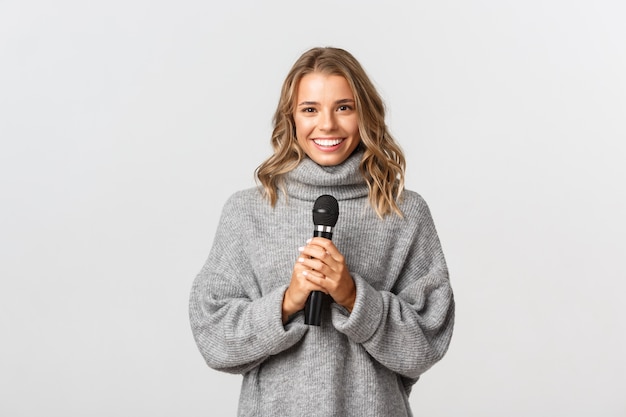 Beautiful woman in a grey sweater posing