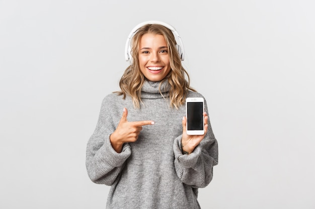 Beautiful woman in a grey sweater posing