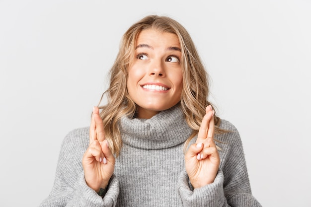 Beautiful woman in a grey sweater posing