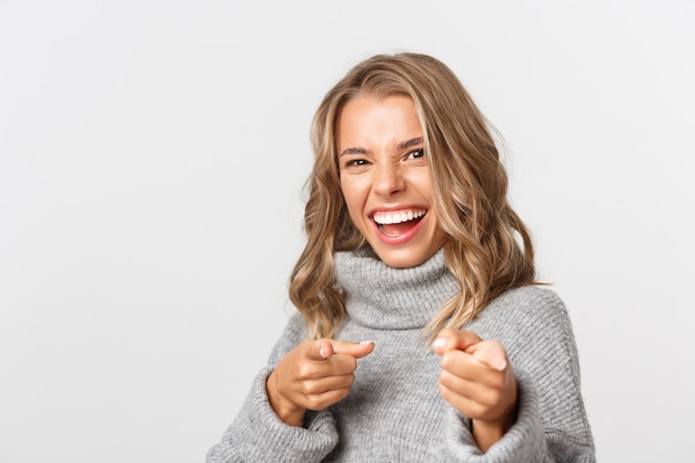 Beautiful woman in a grey sweater posing