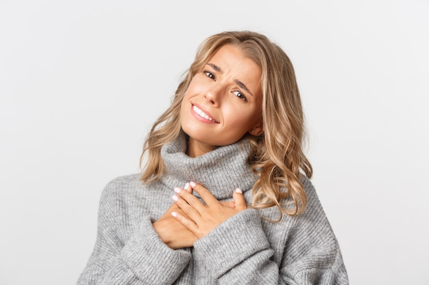 Beautiful woman in a grey sweater posing