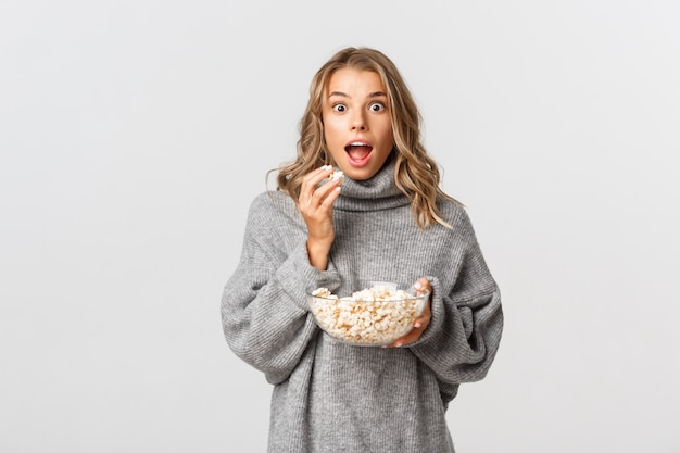 Beautiful woman in a grey sweater posing