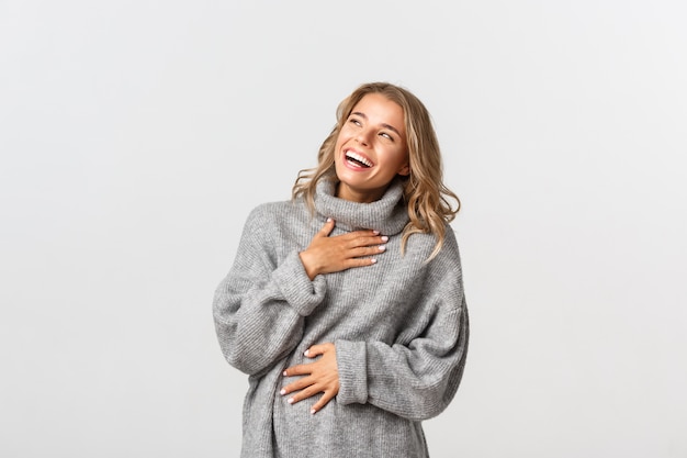 Beautiful woman in a grey sweater posing