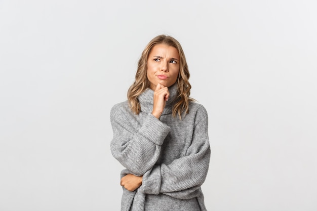 Beautiful woman in a grey sweater posing