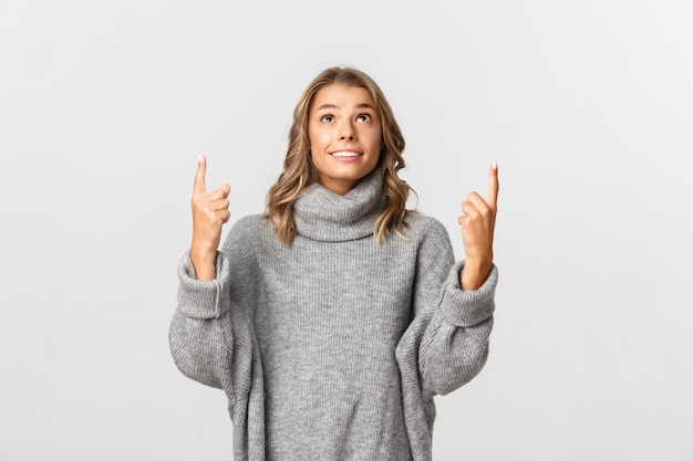 Beautiful woman in a grey sweater posing