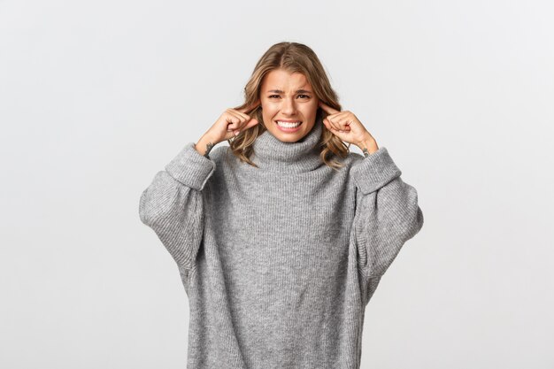 Beautiful woman in a grey sweater posing