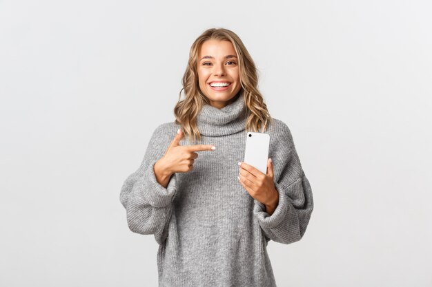 Beautiful woman in a grey sweater posing