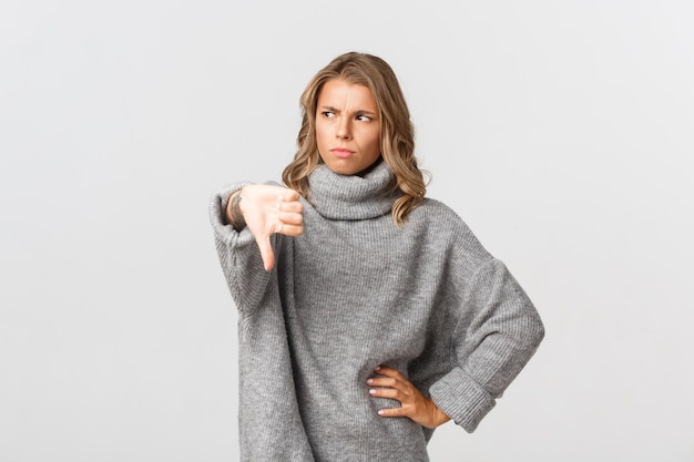 Beautiful woman in a grey sweater posing