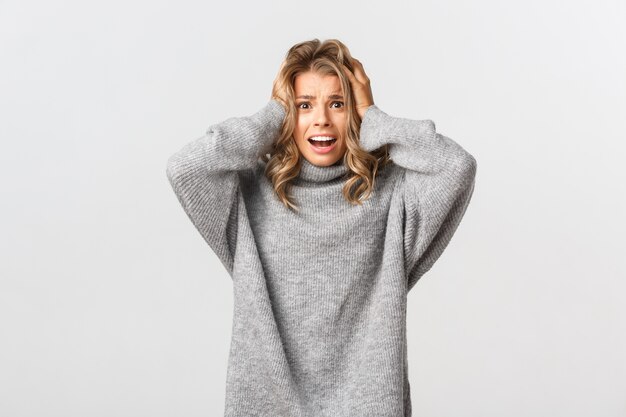 Beautiful woman in a grey sweater posing