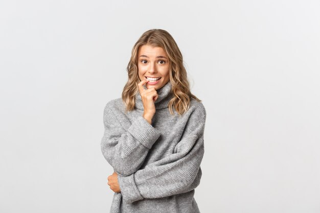 Beautiful woman in a grey sweater posing