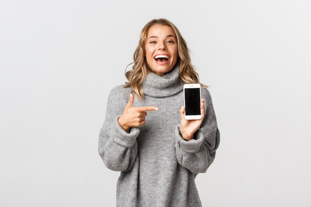 Beautiful woman in a grey sweater posing