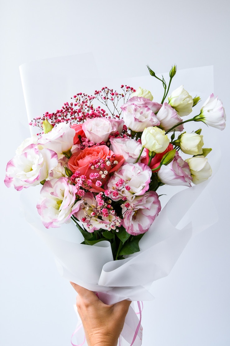 Photo beautiful woman hands hold bouquet of different flowers white and purple on white background. no people. faceless