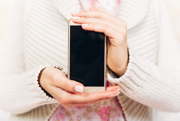 Beautiful woman hands holding phone.