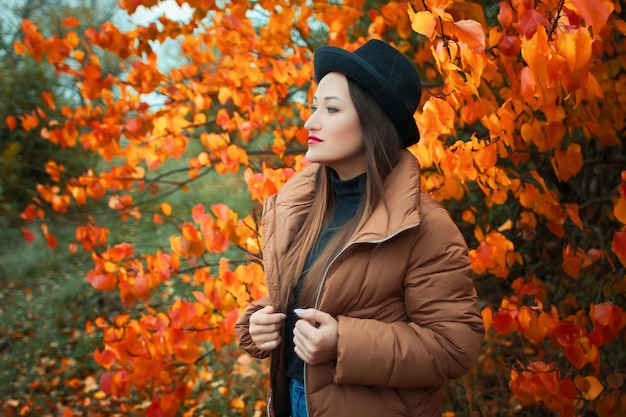 beautiful woman in hat in autumn in the Park