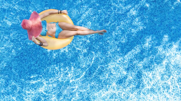 Beautiful woman in hat in swimming pool