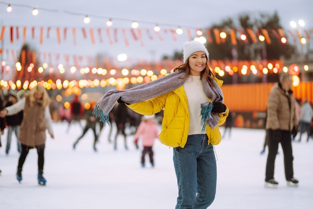 Beautiful woman have fun, active ice skating. Winter holidays concept.