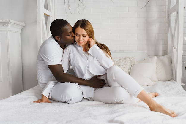 Beautiful woman and her husband sitting in bed
