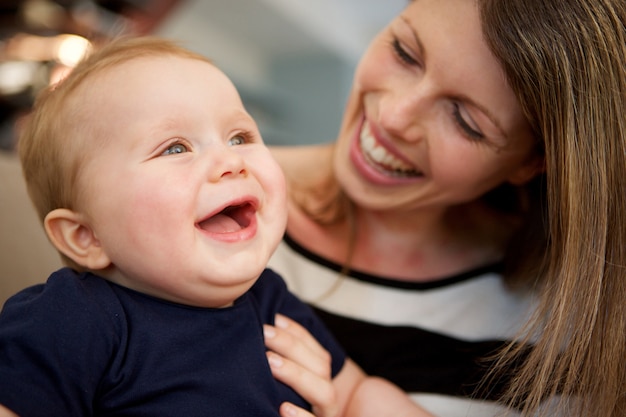 Beautiful woman and her little boy laughing together