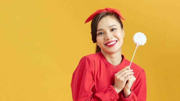 Beautiful woman holding big lollipop candy in hand Sweet food fun concept