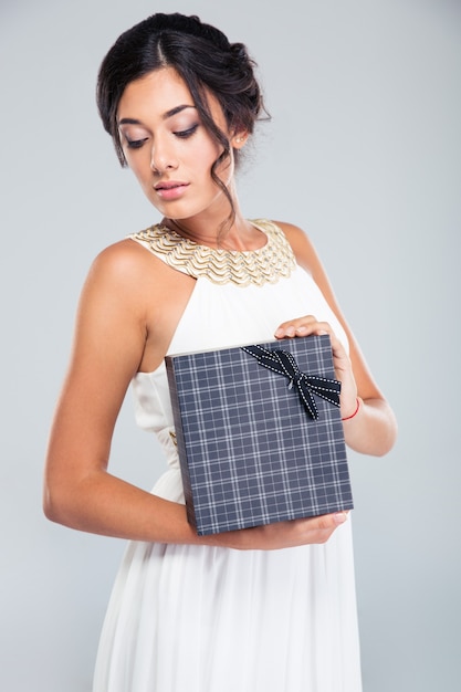 Beautiful woman holding gift box