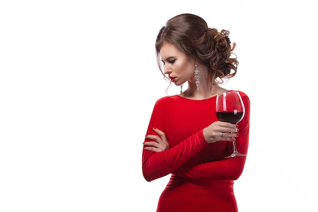 Beautiful woman holding glass of wine onwhite space