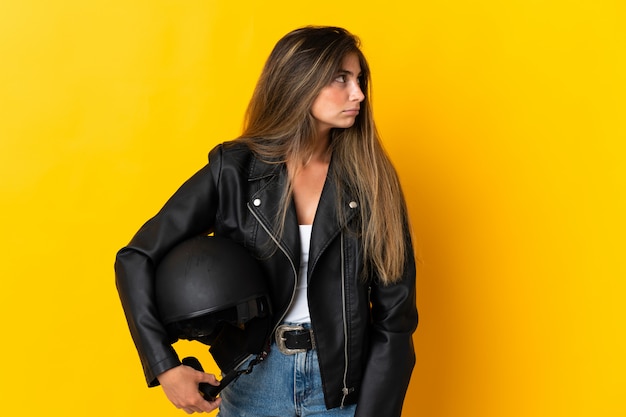 Beautiful woman holding a motorcycle helmet