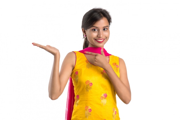 Beautiful woman holding and presenting something on the hand with happy smiling.
