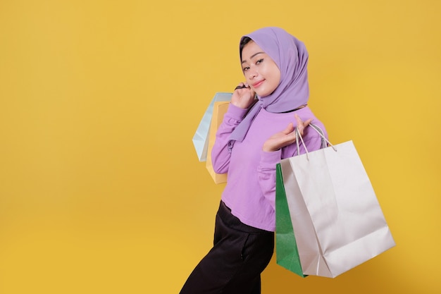 Beautiful woman holding shopping bags, nicely and good mood