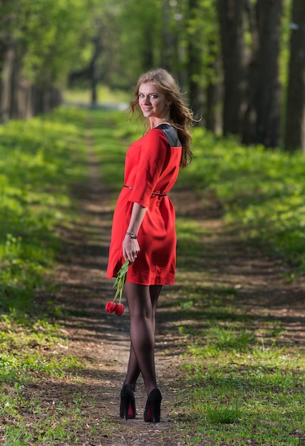 Beautiful woman holding a tulip