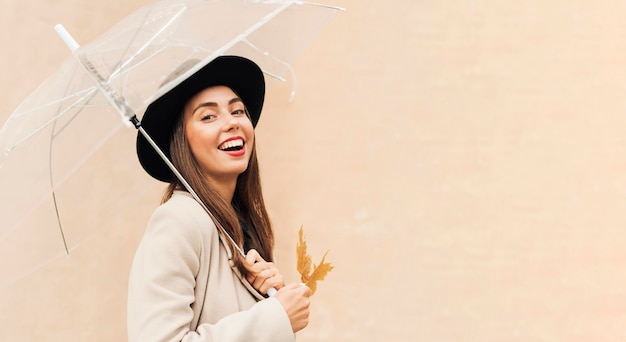 Photo beautiful woman holding an umbrella with copy space