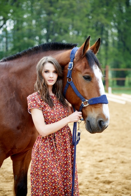 Beautiful woman and horse outdoors.