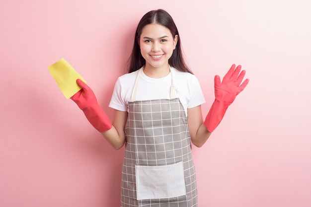 Beautiful woman housekeeper portrait on pink background