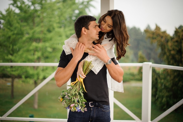 Beautiful woman hugging her boyfriend from back