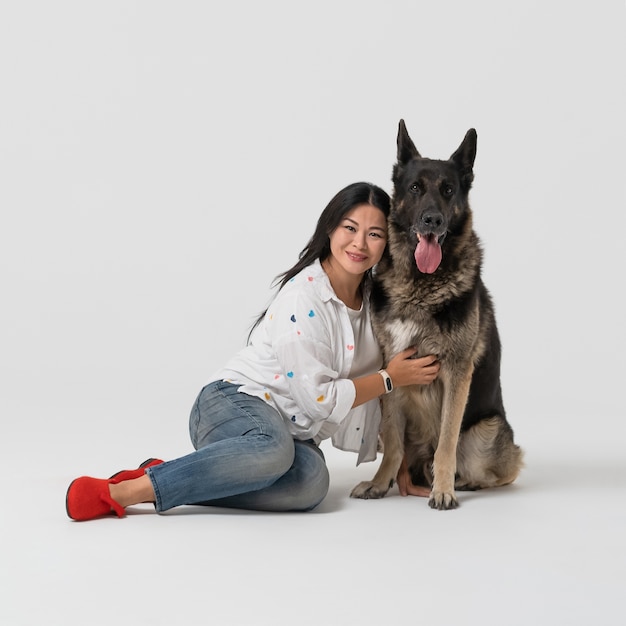 Beautiful woman hugs thoroughbred Shepherd dog