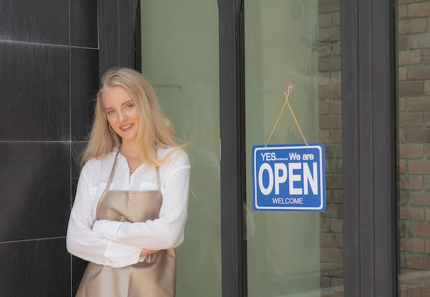 Beautiful woman is happy to open a coffee shop after closing shop during the coronavirus outbreak