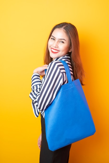 Beautiful woman is holding blue cloth bag