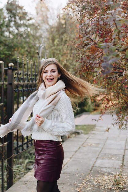 Beautiful woman is posing outdoor in sunny weather