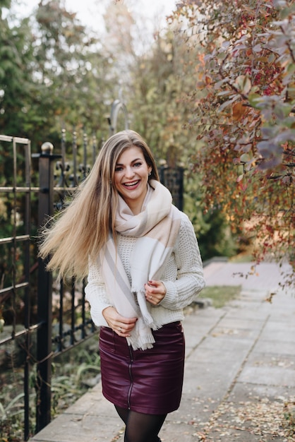 Beautiful woman is posing outdoor in sunny weather