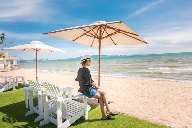 Beautiful woman is relaxing on the beach , under umbrella 