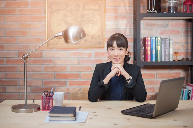 Beautiful woman is relaxing in modern home office