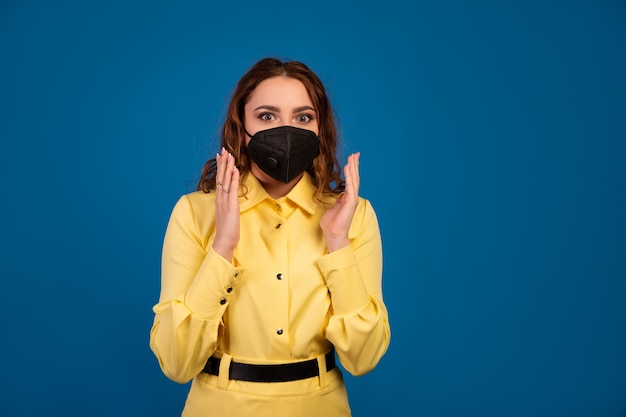 a beautiful woman is waving her arms and is shocked by the spread of the coronavirus