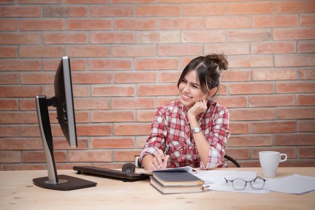 Beautiful woman is working in home office 