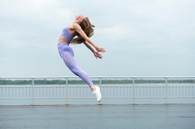 Beautiful woman jumping long shot